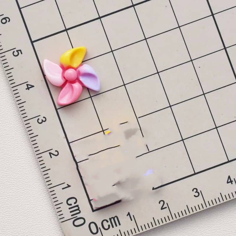 You can make a cute twirling pen with pinwheel decoration parts.